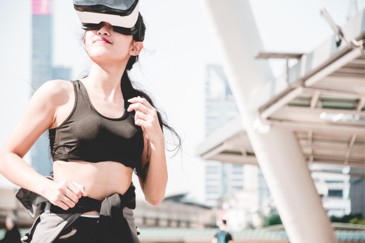 A girl playing sports game with virtual reality glasses