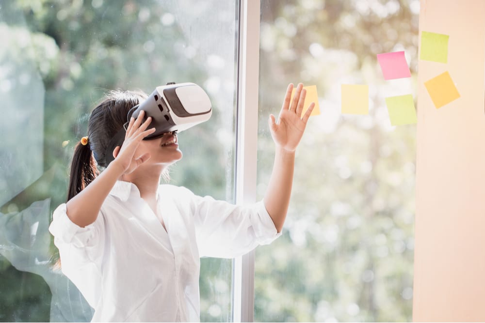 Virtual Reality interaction by asian young female wearing vr headset